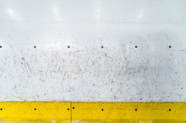 Hockey rink boards with scratched and damaged surface