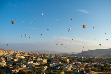 Aerial view on Sunrise over Cappadocia. Balloons flying against blue sky. Goreme most popular place in Turkey 