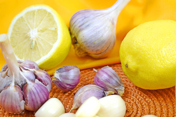 Healthy lemon drink and fresh garlic.