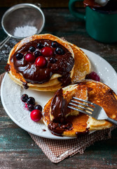 Pancakes with berries and chocolate sauce