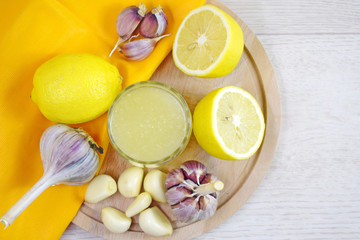 Healthy lemon drink and fresh garlic.