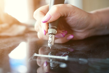 Girl engraves on granite