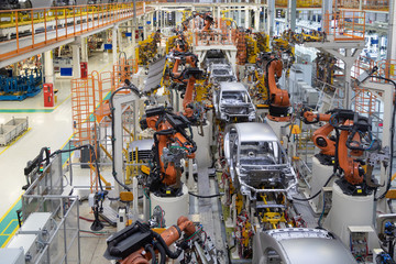 body of car on conveyor top view. Modern Assembly of cars at the plant. The automated build process...