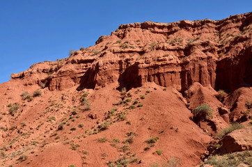 Fototapeta premium Red sandstone rocks of Konorchek canyon,Kirgyzstan,Central Asia, famous trekking place