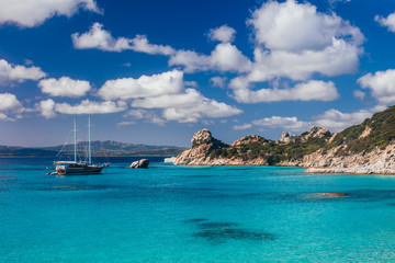 Amazing azure clear sea water with yacht in Sardinia island, Italy