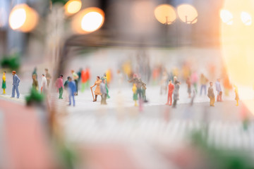 miniature people walking on streets,people are moving across the pedestrian crosswalk in the city road