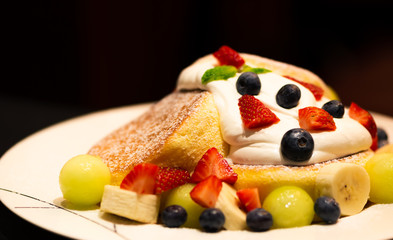 Pancake with strawberry, blueberry, banana, berry sauce and mascarpone cheese cream.