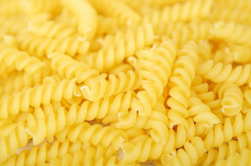 Pasta fusilli close-up. Ingredient for the preparation of hearty dishes