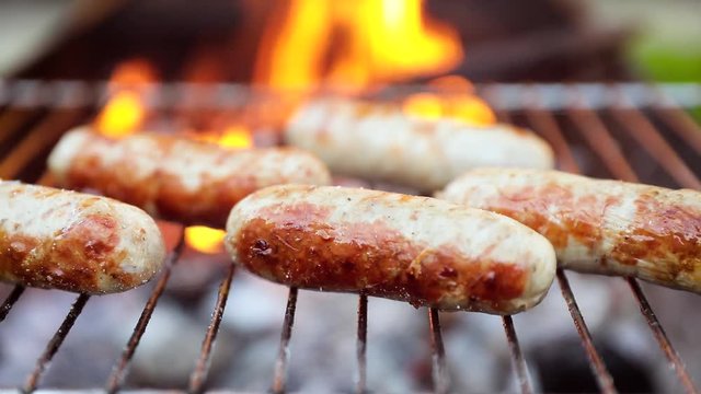 Delicious juicy sausages, cooked on the grill with a fire