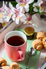 Homemade breakfast: rolls and cup of tea on vintage serving tray.