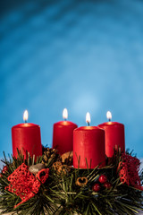 Christmas burning candles on a blue background