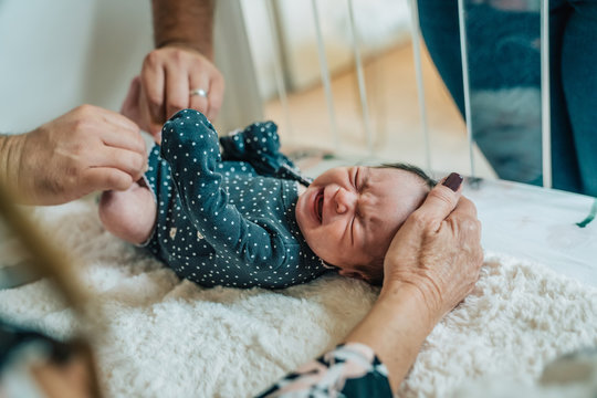 Father changing newborn baby's clothing