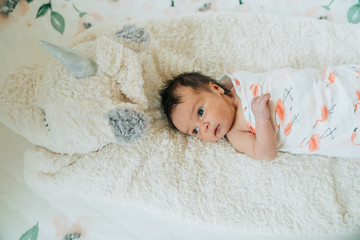Newborn baby in a swaddle lying down