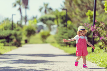little girl runing in the summer Park