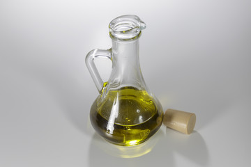 Olive oil in the jar, isolated on white. Ingredients of a vegan food.