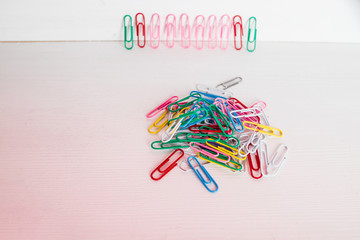 multi colored paper clips lined up in a row. Colorful bunch of paper clip.Selective focus.Copy space.School supplies, Office supplies, Back to school, Arts and crafts material. Creative minimalism