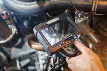 Inspection of a gas turbine engine using a Video Endoscope. Search for defects inside the turbine...
