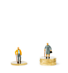 Small figurines and coins. Gender pay gap.
