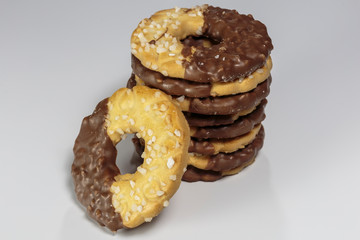 Pile of delicious ring-shaped chocolate chip cookies on a white background closeup.