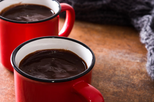 Hot chocolate in mug on rusty background