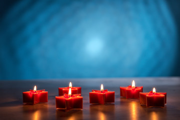 Christmas burning candles on a blue background