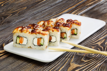 Japanese rolls, sushi on wooden background