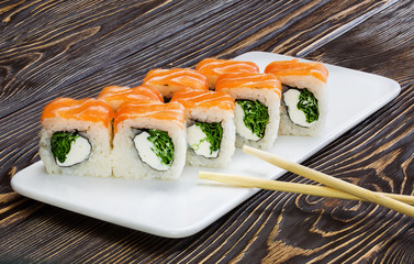 Japanese rolls, sushi on wooden background