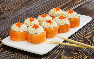 Japanese rolls, sushi on wooden background