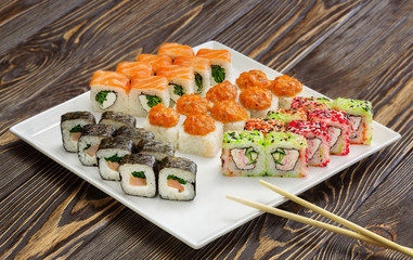 Japanese rolls, sushi on wooden background