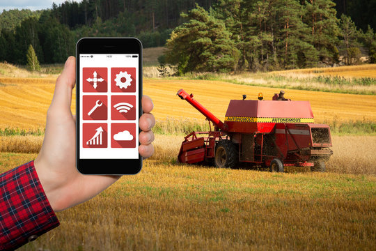 Autonomous combine harvester on a wheat field.