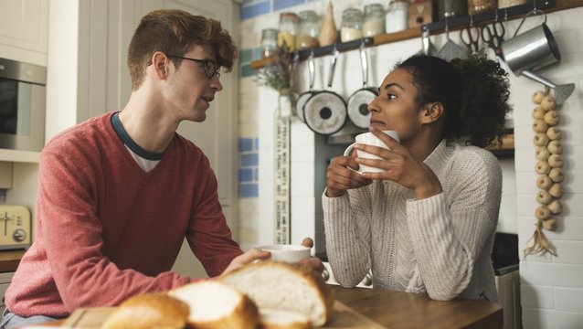Couple having coffee in kitchen