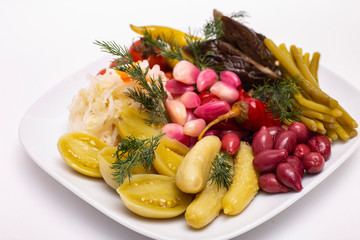 Pickles in assortment on a plate. Restaurant dish.
