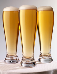 THREE TALL GLASSES OF BEER