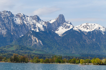 Stockhorn of Bernese Alps with lake Thun looking from street in village