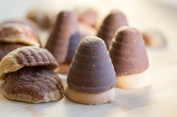 Various kinds of Christmas cookies, cocoa wasp nests and cinnamon sandbakelse sweets on wooden table