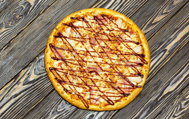 Italian pizza on wooden background, top view