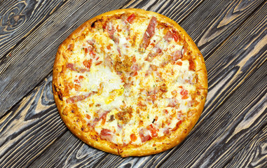 Italian pizza on wooden background, top view