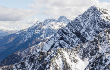 High peaks, lots of white snow in the mountains and clouds cling to the peak in the mountains of Sochi and the ski slope, Russia