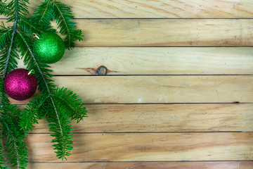 Greenery with green and red ornaments  along left side border with copy space
