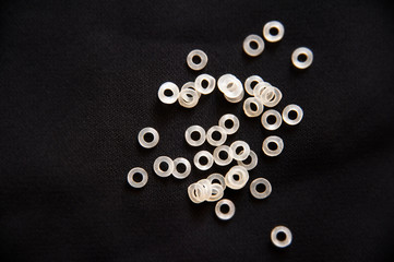 The elastics rubber bands for the braces on the teeth are chaotic on a black background