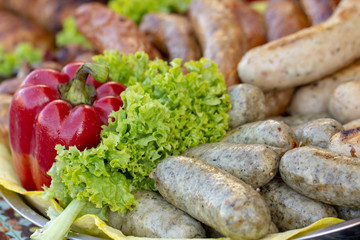 Grilled smoked sausages and meatballs outdoors. Meat baked on the grill bbq. Meat delicacies. Sausages homemade sausages on the grill.
