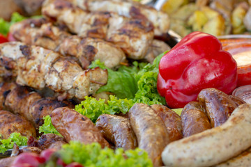 Grilled smoked sausages and meatballs outdoors. Meat baked on the grill bbq. Meat delicacies. Sausages homemade sausages on the grill.