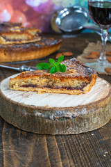 Traditional home baked bakewell tart on rustic wooden board