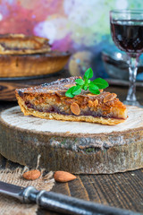 Traditional home baked bakewell tart on rustic wooden board