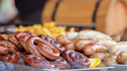 Grilled smoked sausages and meatballs outdoors. Meat baked on the grill bbq. Meat delicacies. Sausages homemade sausages on the grill.