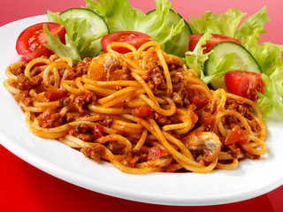 PLATE OF SPAGHETTI BOLOGNESE WITH SALAD