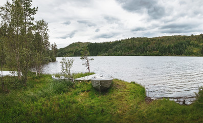 Fototapeta na wymiar Picturesque panoramic rural view with boats near the Langelandsvatnet lake, Sogn og Fjordane, Western Norway. Norwegian fjord landscape in summertime