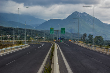 empty highway car road in gray rainy weather time before storm in beautiful nature landscape environment with mountains horizon background 