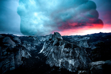 Huge cloud overing over a mountain at sunset