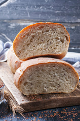 Homemade  freshly baked  bread with flax seeds  on dark wooden b